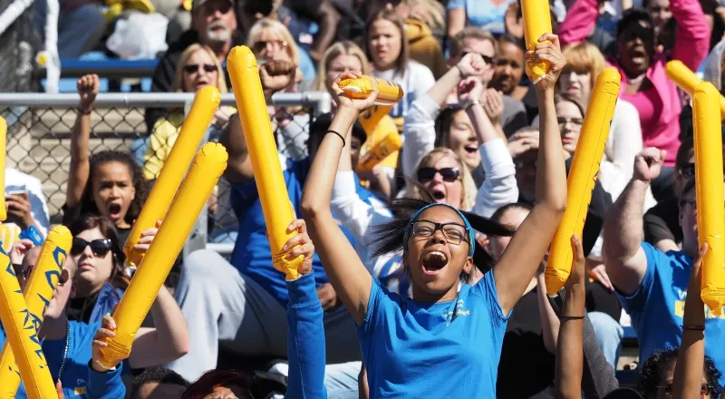 Students cheer at homecoming football game