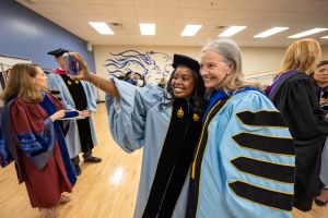 Stacey Robertson and student trustee Ijjae Hill take a selfie at inauguration.
