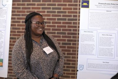 Taylor Easter next to her SURCA poster