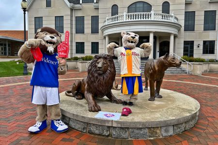 Widener mascots Chester and Melrose at the pride statue in Phillies gear.