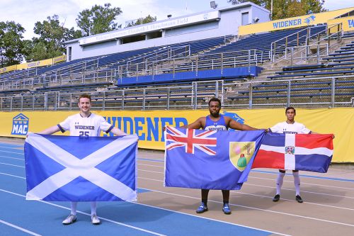 International Student Athletes 960x640 Three international student athletes stand on the stadium track holding their country flags