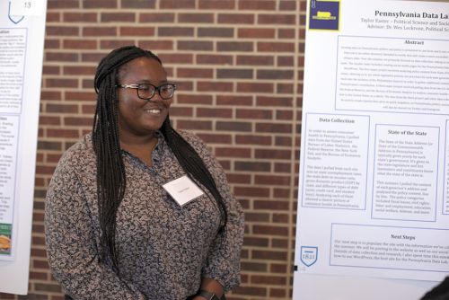 Taylor Easter next to her SURCA poster