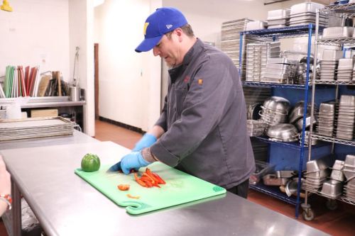 Executive Chef Matthew Clarke chopping peppers in the Widener Dining kitchen.