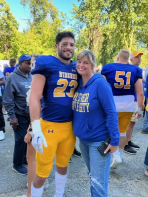 Kim Robinson with son in Widener football gear