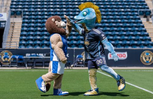 Chester and Phang mascots high-fiving on the field at the Philadelphia Union