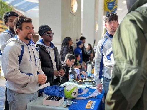 Widener Involvement Fair 500x375 Members of Widener Men's Rugby, a club sport, talk to a prospective member at the Widener Involvement Fair.