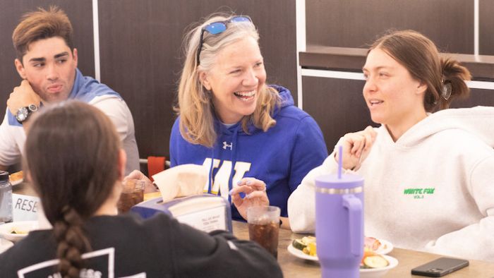 president stacey robertson with widener students at pride cafe